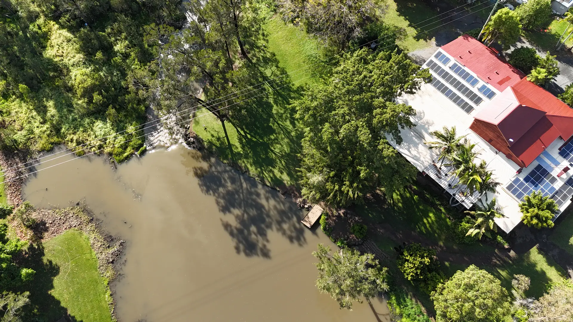Aerial view of the lawns and riverside spaces at Historic Rivermill